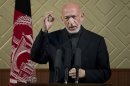 Afghan President Hamid Karzai gestures during a ceremony at Kabul University in Kabul, Afghanistan, Thursday, May 9, 2013. Karzai said he is ready to let the U.S. have nine bases in the country after the 2014 combat troop pullout, but wants Washington's 