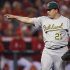 Oakland Athletics starting pitcher Bartolo Colon celebrates the last out against the Los Angeles Angels in the eighth inning of a baseball game in Anaheim, Calif., Wednesday, April 18, 2012. (AP Photo/Chris Carlson)