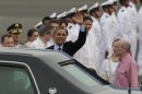 President Barack Obama waves upon arrival to Cartagena, Colombia, Friday April 13, 2012. Obama is in Cartagena to attend the sixth Summit of the Americas. At right is U.S. ambassador to Colombia Michael McKinley. (AP Photo/Dolores Ochoa)