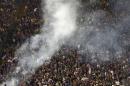 Supporters are seen behind smoke from flares before the Italian Cup final soccer match between Fiorentina and Napoli at the Olympic stadium in Rome