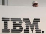 A worker is pictured behind a logo at the IBM stand on the CeBIT computer fair in Hanover February 26, 2011. REUTERS/Tobias Schwarz/Files