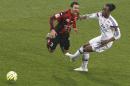 Nice's Carlos Eduardo De Oliveira Alves, left, is tackled by Lyon's Bakary Kone, right, during their French League One soccer match in Lyon, central France, Saturday, March 21, 2015. (AP Photo/Laurent Cipriani)