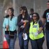 A injured woman, second left, holds her arm as she walks with medical personnel, second right, after she and others were injured during a concert by Linkin Park in Cape Town, South Africa, Saturday, Nov. 7, 2012. The city of Cape Town, South Africa, says that 20 people have been injured after scaffolding collapsed because of high winds outside a concert for Linkin Park. (AP Photo)