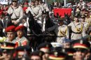 A horse drawn caisson carries the remains of Egypt's former spy chief Omar Suleiman during his funeral in Cairo, Egypt, Saturday, July 21, 2012. The 76-year-old Suleiman died Thursday in a U.S. hospital. The shadowy statesman was considered Mubarak's most trusted man, handing the regime's most sensitive issues like relations with the U.S. and Israel and the fierce battle against Islamists. (AP Photo/Amr Nabil)