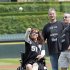 Karen Rand, who lost part of her leg in the Boston Marathon bomb blasts, throws out the ceremonial first pitch before a baseball game between the Chicago White Sox and the Oakland Athletics, Saturday, June 8, 2013. (AP Photo/Charles Cherney)