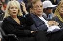 FILE - In this Nov. 12, 2010, file photo, Los Angeles Clippers owner Donald T. Sterling, right, sits with his wife Rochelle during the Clippers NBA basketball game against the Detroit Pistons in Los Angeles. An attorney representing the estranged wife of Clippers owner Donald Sterling said Thursday, May 8, 2014, that she will fight to retain her 50 percent ownership stake in the team. (AP Photo/Mark J. Terrill, File)