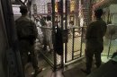 GUANTANAMO BAY, CUBA - MARCH 30: (EDITORS NOTE: Image has been reviewed by the U.S. Military prior to transmission.) U.S. military guards watch detainees in a cell block at Camp 6 in the Guantanamo Bay detention center on March 30, 2010 in Guantanamo Bay, Cuba. U.S. President Barack Obama pledged to close the prison by early 2010 but has struggled to transfer, try or release the remaining detainees from the facility, located on the U.S. Naval Base at Guantanamo Bay, Cuba. (Photo by John Moore/Getty Images)