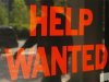 A "Help Wanted" sign in the window advertises a job opening at a dry cleaners in Boston
