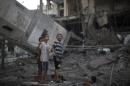 Palestinian youths inspect destruction at a mosque in Gaza City, on July 30, 2014