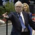 Warren Buffett, chairman and CEO of Berkshire Hathaway tosses a newspaper  during a newspaper tossing competition  in Omaha, Neb., Saturday, May 5, 2012. Berkshire Hathaway is holding it's annual shareholders meeting this weekend. (AP Photo/Nati Harnik)