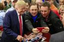 Republican presidential candidate Donald Trump takes a picture with supporters following a rally at West High School in Sioux City, Iowa, Tuesday, Oct. 27, 2015. (AP Photo/Nati Harnik)