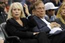 FILE - In this Nov. 12, 2010 file photo, Los Angeles Clippers owner Donald T. Sterling, right, sits with his wife Shelly during the Clippers NBA basketball game against the Detroit Pistons in Los Angeles. Donald Sterling has agreed to surrender his stake of the Clippers to his wife, and she is moving forward with selling the team. A person with knowledge of the negotiations told The Associated Press Friday. May 23, 2014, that the couple made the agreement after weeks of discussion. The individual wasn't authorized to speak publicly about the agreement. (AP Photo/Mark J. Terrill, File)