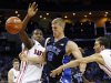 Duke's Mason Plumlee (5) is fouled as he drives between Davidson's De'Mon Brooks, left, and JP Kuhlman, right, during the first half of an NCAA college basketball game in Charlotte, N.C., Wednesday, Jan. 2, 2013. (AP Photo/Chuck Burton)