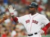 Boston Red Sox Carl Crawford slaps hands with a teammate after scoring a run against the Chicago White Sox during the first inning of American League MLB baseball action at Fenway Park in Boston