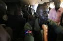 A South Sudan army soldier holds his weapon during a flight from the capital Juba to Bor town