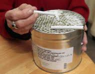 Elvy Musikka, 72, who suffers from glaucoma, shows the canister holding marijuana cigarettes she regularly receives from the U.S. Government in Eugene, Ore., Tuesday, Sept. 27, 2011. For the past three decades, the federal government has been providing a handful of patients with some of the highest grade marijuana around. The program grew out of a 1976 court settlement that created the country’s first legal pot smoker. (AP Photo/Don Ryan)