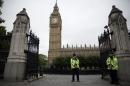 British police officers stand guard outside the Houses of Parliament in London, Monday, Sept. 1, 2014. Britain's Prime Minister David Cameron is expected on Monday to expand powers to combat terrorism in hopes of preventing attacks by Islamist militants returning from terror training in the Middle East. (AP Photo/Matt Dunham)
