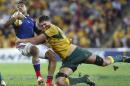 French inside center Wesley Fofana, left, is tackled by Australian lock Rob Simmons during their Rugby test match in Brisbane, Australia, Saturday, June 7, 2014. (AP Photo/Tertius Pickard)