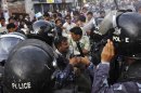 Activists of Nepal's opposition parties scuffle with police during a demonstration against Prime Minister Baburam Bhattarai in Katmandu, Nepal, Wednesday, May 30, 2012. The opposition parties said they will team up to topple the government, as they accused the prime minister Wednesday of having no moral or legal grounds to stay in power ahead of new elections. (AP Photo/Binod Joshi)