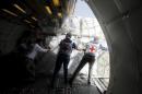 Red Cross staffers unload a shipment of emergency medical aid from a plane at Sanaa airport
