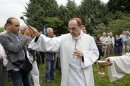 Philippe Barbarin, Archbishop of Lyon, blesses people during the first stone ceremony of the future Saint-Thomas catholic church