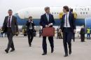 U.S. Secretary of State Kerry walks to his car with Austria's Foreign Minister Kurz as he arrives at Vienna International Airport