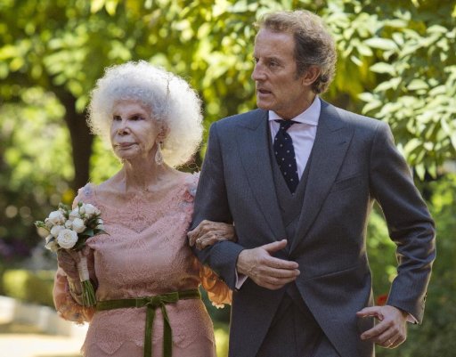 Maria del Rosario Cayetana Alfonsa Victoria Eugenia Francisca Fitz-James Stuart, Spanish Duchess of Alba, and her husband Alfonso Diez walk out of the chapel after their wedding at Las Duenas Palace in Seville, Wednesday Oct. 5, 2011. A wealthy, 85-year-old Spanish Duchess of Alba considered the world's most title-laden noble married a civil servant 25 years her junior, shrugging off her children's qualms and celebrating by kicking off her shoes and dancing a bit of flamenco.(AP Photo/Miguel Angel Morenatti)