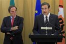 Portuguese Foreign Affairs Minister Paulo Portas listens to Prime Minister Pedro Passos Coelho during a statement to the media in Lisbon