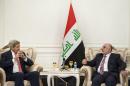 US Secretary of State John Kerry (L) listens as new Iraqi Prime Minister Haider al-Abadi speaks after a meeting on September 10, 2014 in Baghdad
