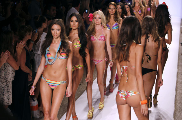 Models wear swimwear from the collection of  Luli Fama during the Mercedes-Benz Fashion Week Swim 2013 show, Sunday, July 22, 2012, in Miami Beach, Fla. (AP Photo/Lynne Sladky)