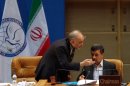 Iranian Foreign Minister Ali Akbar Salehi (L) chats with Iranian President Mahmoud Ahmadinejad