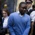 Alleged renegade UBS trader Kweku Adoboli, center, walks to a security van flanked by police officers after appearing at the City of London Magistrates Court in London, Friday, Sept. 16, 2011. The alleged renegade trader accused of losing Swiss bank UBS about $2 billion in unauthorized trading was ordered held in prison custody Friday charged with fraud and false accounting. Adoboli, 31, will be held until another court appearance on Sept. 22, presiding magistrate Carolyn Wagstaff said. (AP Photo/Matt Dunham)