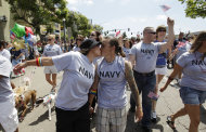 FILE - In this July 16, 2011 file photo, two women, both active duty sailors in the Navy who gave their names as Nikki, left, and Lisa, kiss as they march in the Gay Pride Parade in San Diego. The Defense Department on Thursday, July 19, 2012 announced it is allowing service members to march in uniform in a gay pride parade for the first time in U.S. history. The department said it was making the exception for Saturday's San Diego Gay Pride Parade because organizers had encouraged military personnel to march in their uniform and the event was getting national attention. (AP Photo/Gregory Bull, File)