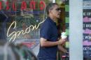 U.S. President Barack Obama carries a shave ice out of Island Snow near his vacation home in Kailua