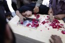The sister of a Pakistani man who lost his life in Friday's crash of a Bhoja Air Boeing 737 passenger plane cries over his coffin outside a hospital in Islamabad, Pakistan, Saturday, April 21, 2012. Pakistan blocked the head of the airline whose jet crashed near the capital from leaving the country as it began an investigation Saturday into the country's second major air disaster in less then two years. (AP Photo/Muhammed Muheisen)