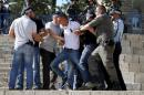 Israeli police officers scuffle with a Palestinian protester as they disperse a protest outside Jerusalem's Old City
