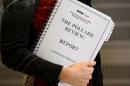 A journalist holds a copy of the Pollard Report into the BBC's handling of the child-sex abuse claims against late presenter Jimmy Savile upon the reports publication at BBC Broadcasting House in London on December 19, 2012