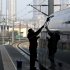 In this Tuesday Feb. 28, 2012 photo, a worker cleans exterior of a CRH high-speed train at Tianjin Railway Station in Tianjin, China. A section of a high-speed railway line that had already undergone test runs has collapsed in central China following heavy rains, the latest accident since a crash last summer that killed 40 people, state media reported Monday March 12, 2012. (AP Photo/Alexander F. Yuan)