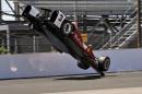The car driven by Helio Castroneves, of Brazil, flips after hitting the wall in the first turn during practice for the Indianapolis 500 auto race at Indianapolis Motor Speedway in Indianapolis, Wednesday, May 13, 2015. (AP Photo/Dick Darlington)