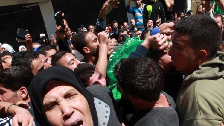 Palestinians mourn during the funeral of Hamza Abu Al-Heja, a member of the military wing of Hamas, during his funeral in the northern West Bank city of Jenin, on March 22, 2014
