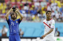 Costa Rica's Celso Borges, right, waits for play to resume as Italy's Andrea Pirlo cools off with water during the group D World Cup soccer match between Italy and Costa Rica at the Arena Pernambuco in Recife, Brazil, Friday, June 20, 2014. (AP Photo/Ricardo Mazalan)