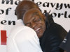 Former heavyweight champion Mike Tyson hugs fellow former champion Evander Holyfield during a promotional event for Holyfield's Real Deal barbecue sauce at a Chicago grocery store Saturday, Feb. 16, 2013. (AP Photo/Charlie Arbogast)