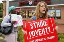 Strikers march outside a Wendy's restaurant in Boston