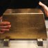 Visitors touch a 220 kg gold bar on display at the Jinguashi Gold Ecological Park in Xinbei city