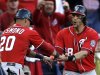 Washington Nationals' Ian Desmond, left, and Michael Morse celebrate after scoring on a two-RBI single by Tyler Moore during the eighth inning in Game 1 of baseball's National League division series against the St. Louis Cardinals, Sunday, Oct. 7, 2012, in St. Louis. (AP Photo/Jeff Roberson)