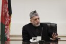 Afghan President Hamid Karzai listens to speeches of a family member,unseen, of Afghan civilians who were killed Sunday by a US soldier in Panjwai in Kandahar province at the presidential palace in Kabul, Afghanistan, Friday, March 16, 2012. Afghan President Hamid Karzai lashed out at the United States on Friday, saying he is at the 