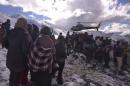 Handout photo of people gathering near a helicopter belonging to Nepal Army used to rescue avalanche victims at Thorang-La in Annapurna Region