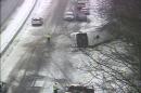 In this image from a Connecticut Department of Transportation traffic camera, a bus lies on the shoulder of northbound Interstate 95 Monday, Feb. 8, 2016, in Madison, Conn. The charter bus on its way from New York city to the Mohegan Sun casino crashed during a snowstorm, leaving at least 30 people injured, several critically, and closed the northbound side of the highway. (Connecticut Department of Transportation via AP)