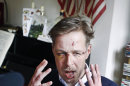 Wilfred de Bruijn, a Dutch citizen who lives and works as a librarian in Paris, France, gestures during an interview with The Associated Press at his apartment in Paris, Wednesday, April 10, 2013. De Bruijn was beaten unconscious near his home early Sunday morning in central Paris, sustaining 5 fractures in his head and face, abrasions and a lost tooth. After posting a photo of his wounds on Facebook, the image went viral and de Bruijn has become a national cause celebre of the pro-gay campaign. (AP Photo/Remy de la Mauviniere)