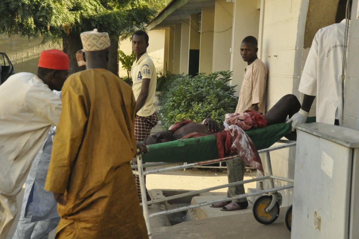 A injured man is wheeled into hospital, following an explosion at a Mosque, in Kano, Nigeria, Friday Nov. 28, 2014. An explosion tore through the central mosque in Nigeria's second-largest city on Friday, and officials feared the casualty toll would be high. Capt. Ikechukwu Eze said the Friday blast occurred at the main mosque in the city of Kano. Hundreds had gathered to listen to a sermon in a region terrorized by attacks from the militant group Boko Haram. (AP Photo/Muhammed Giginyu)